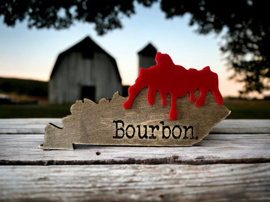 Kentucky state shaped table top decor sign with red bourbon drip. Laser engraved on maple. Display easel/stand included.